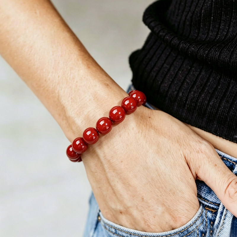 cinnabar bracelet stand 01 genuine cinnabar stone bracelet on solid surface for spiritual grounding